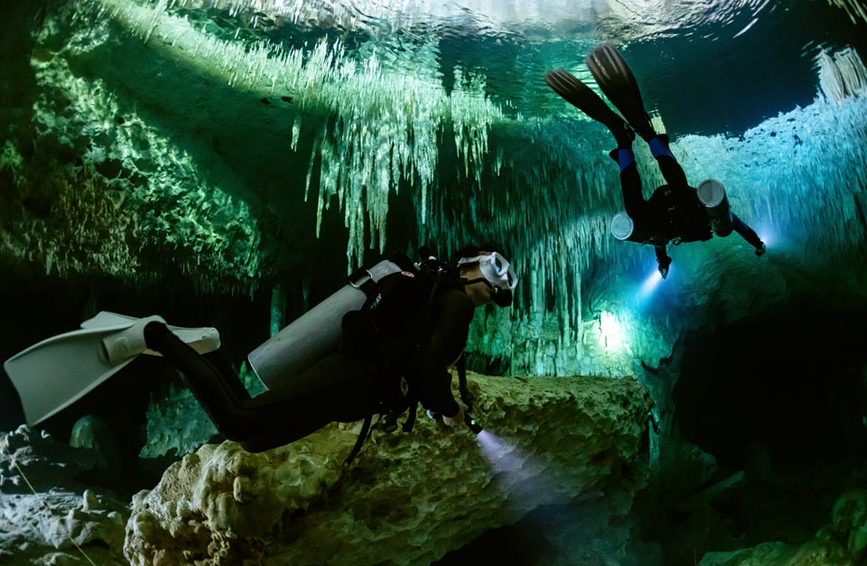 recreational scuba divers diving in a Cenote