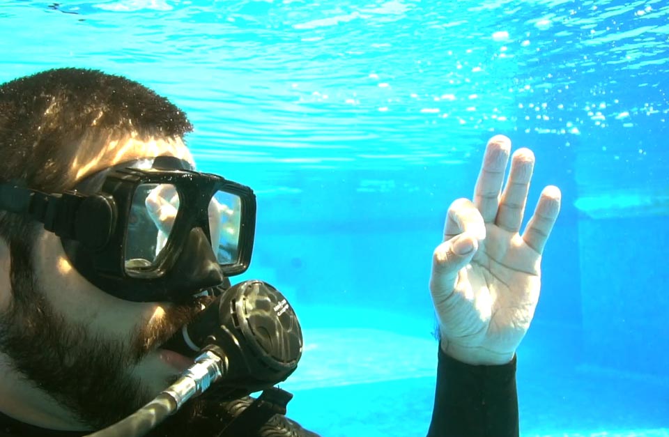 scuba diver giving the ok signal